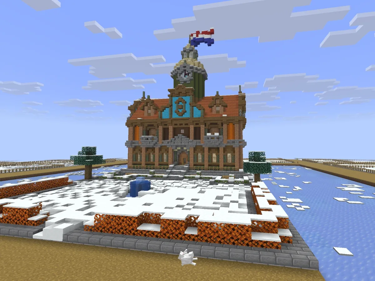 Het gemeentehuis in ons Minecraft-dorp, met een Nederlandse vlag op de toren